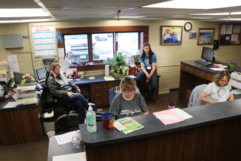 Women working in the office of the Kist Livestock Auction, include Lacey Maeir, 34, and her friend and coworker, Halle Burghart, 23, whose ranches both were hit with Blizzard Haley.