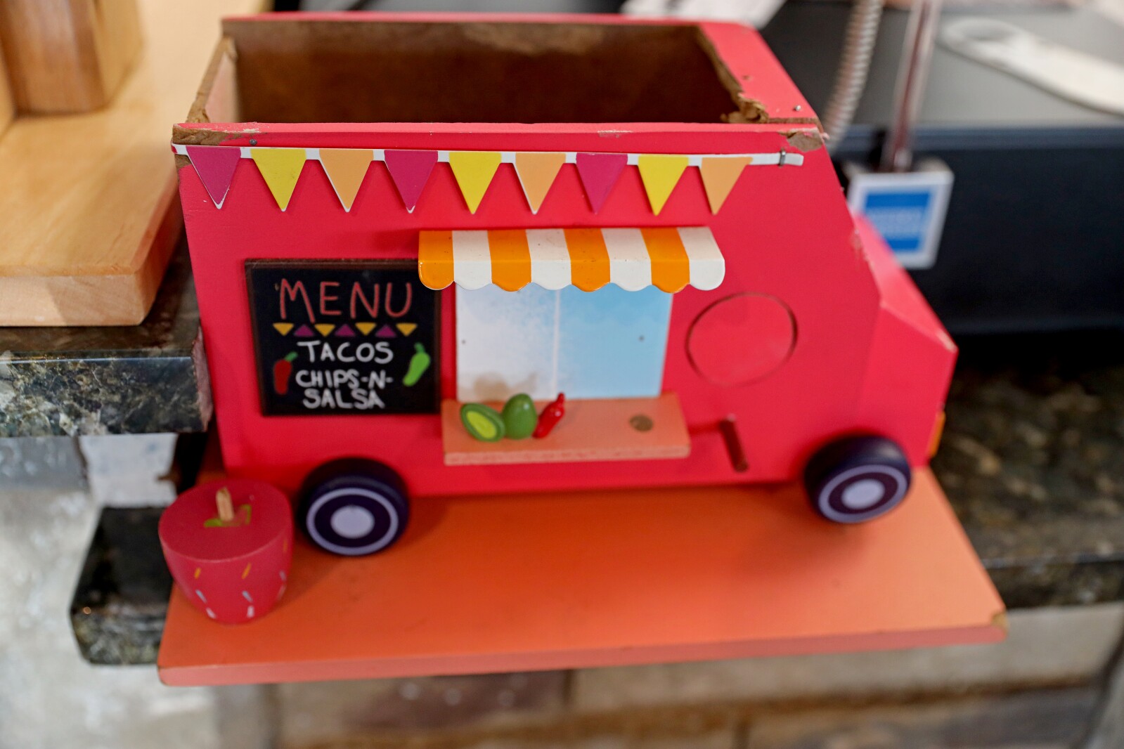 Small, red taco truck replica sits on counter