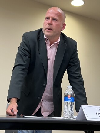 Candidate stands as he answers a question during a forum