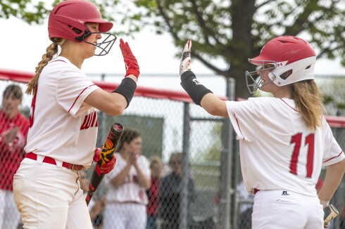 Willmar freshman Madison Norsten, at left, gives a high five to junior Cadence Parker during a Section 8AAA playoff game against Sauk Rapids in Willmar on Tuesday, May 24, 2022.