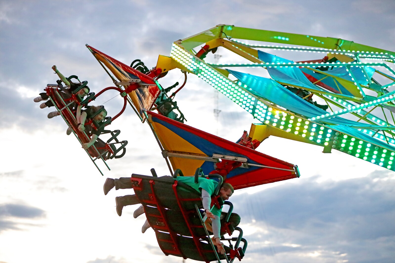 The fair midway ride Soarin' spins people around.