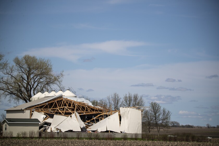 A metal building sits heavily damaged north of Murdock on Friday, May 13, 2022, following heavy storms in the region the evening prior.