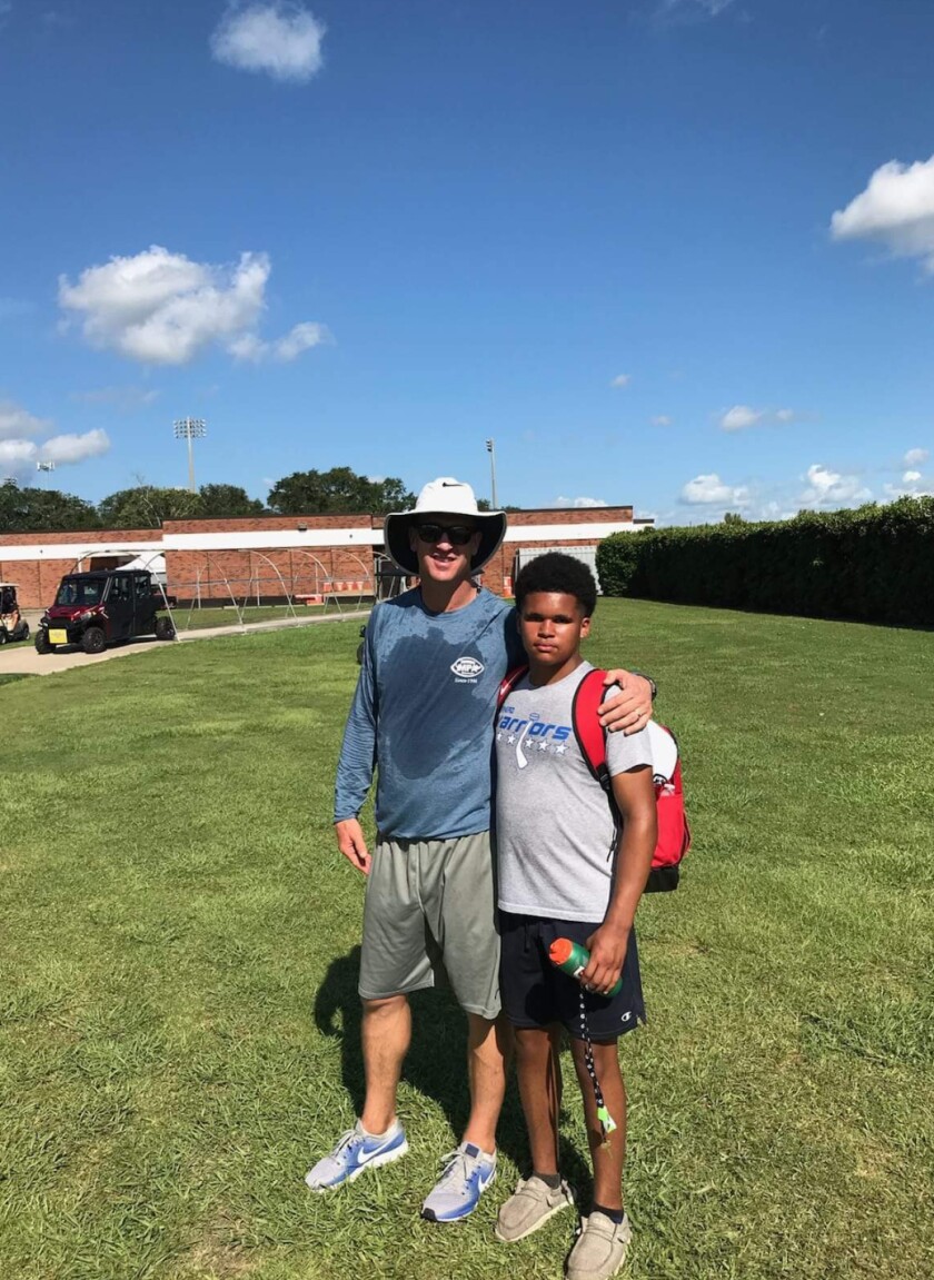 Brainerd's Damien Bentho finds a free moment from working out at the Peyton Manning Passing Academy to snap a photo with the future hall of fame quarterback.