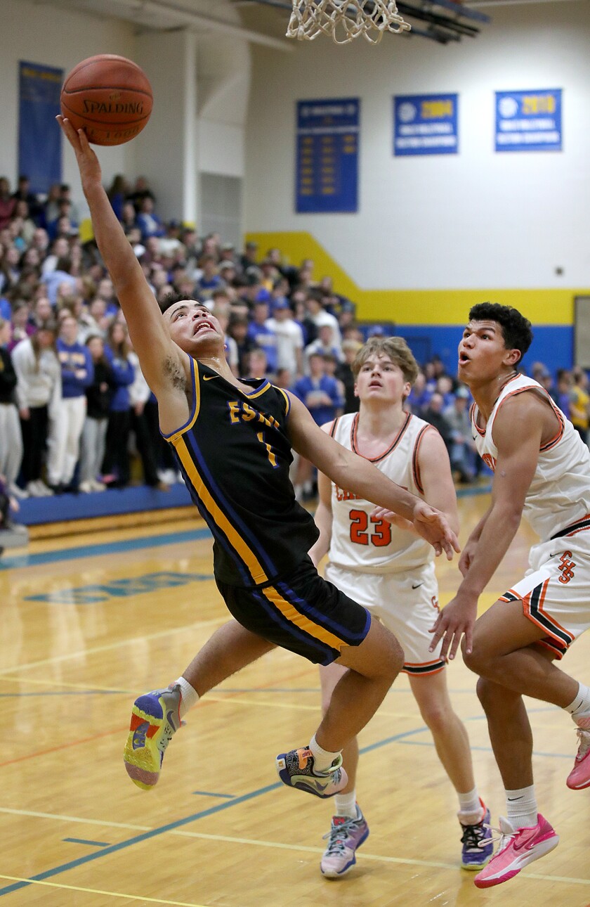 A player shoots a layup.