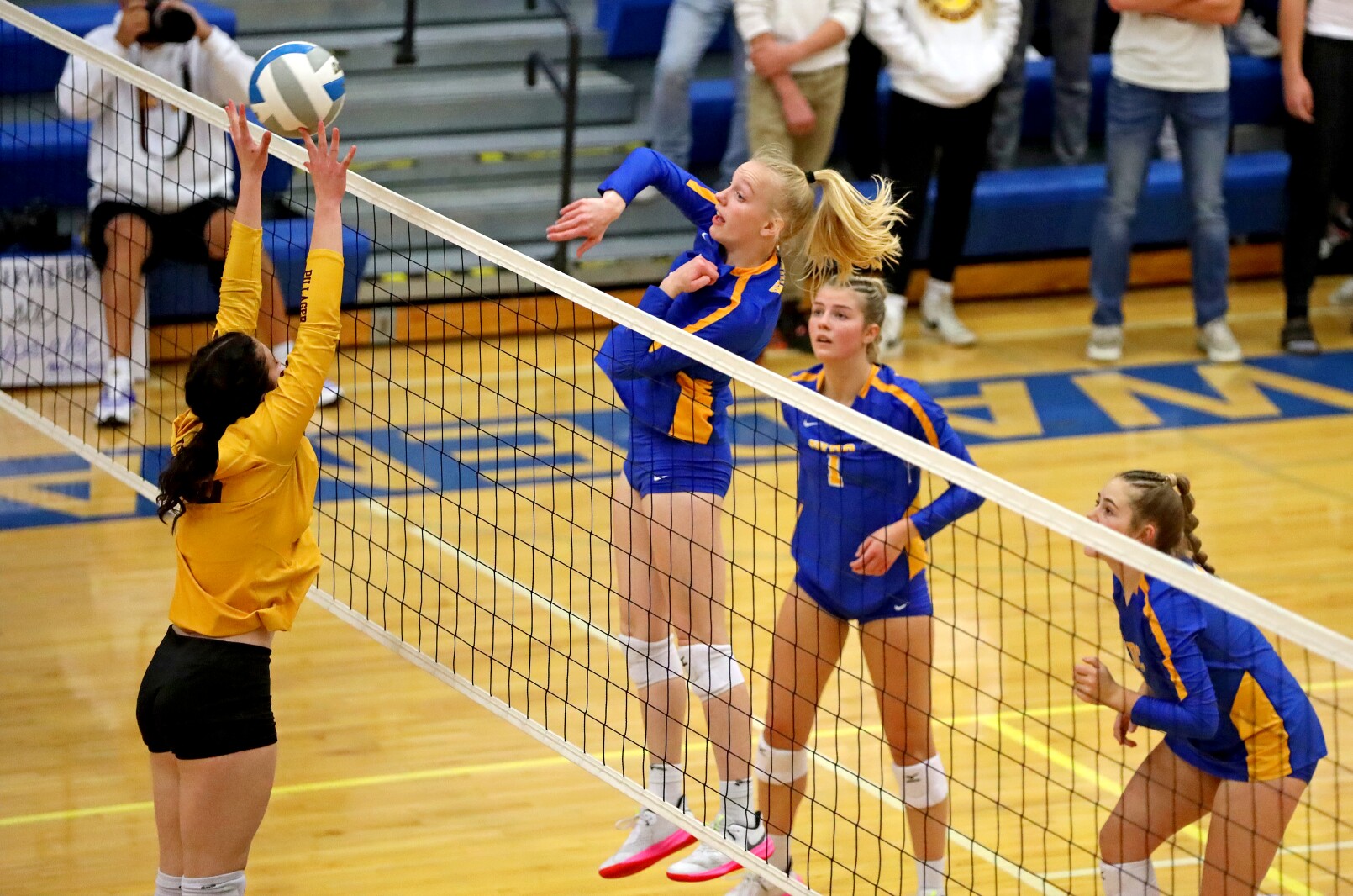 Volleyball players at the net.
