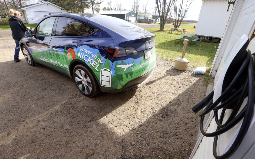 A Tesla vehicle wrapped in Talon Metals' logo.