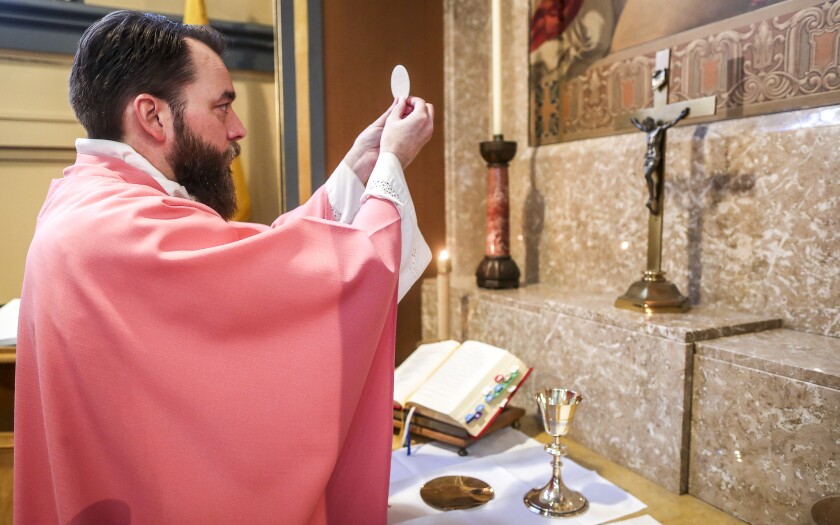 File: Queen of Peace Catholic Church Father Fish.jp