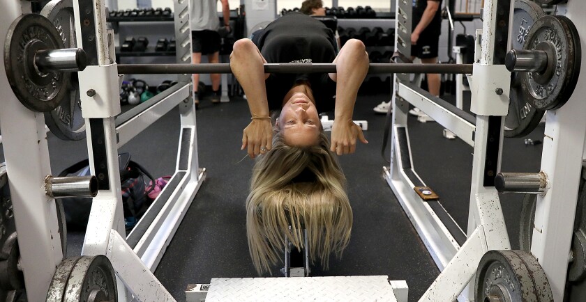 Powerlifter Char Balcer arches her back as she gets herself in position to bench