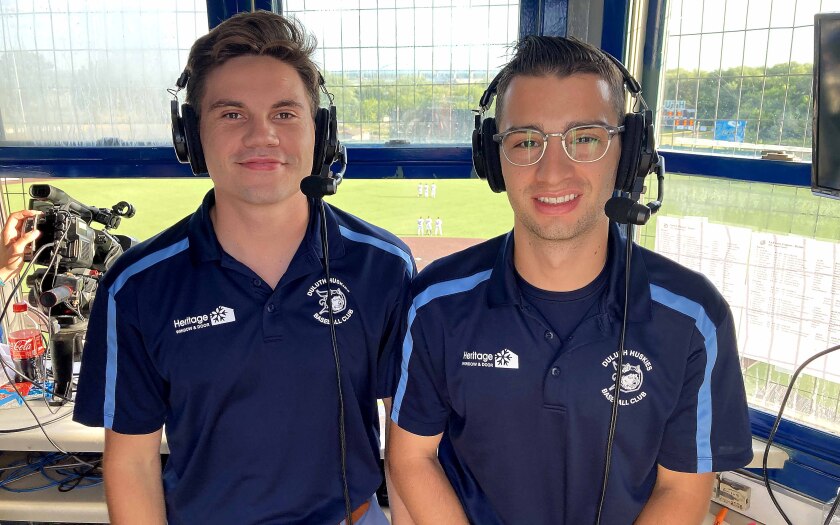 Two broadcasters with the Duluth Huskies smiling