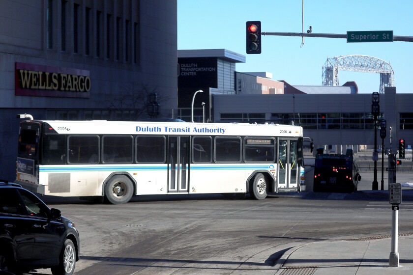 A city bus turning left at an intersection.