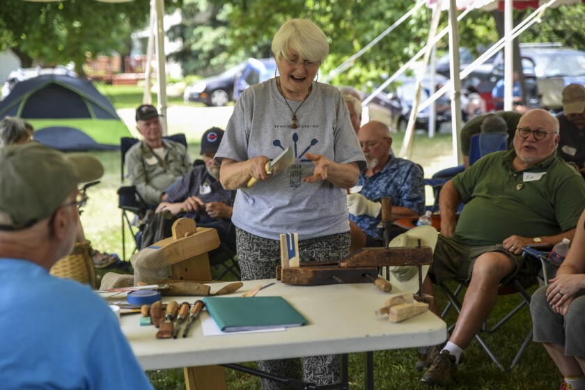 Erica Dischino / TribuneCarver Jane Mickelborough of Brittany in France presents attendees with the Brenton-style spoon sculpture during the 12th annual spoon gathering June 1 in Milan.