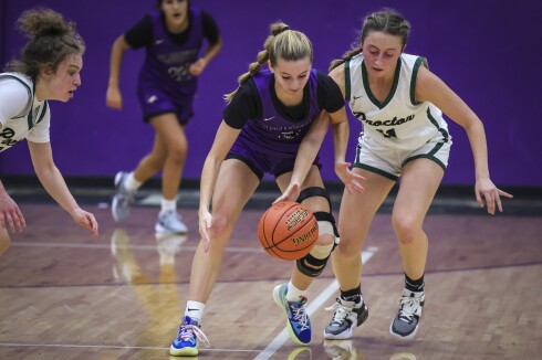 high school girls play basketball