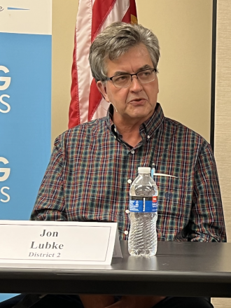 Candidate answers question while seated at a table
