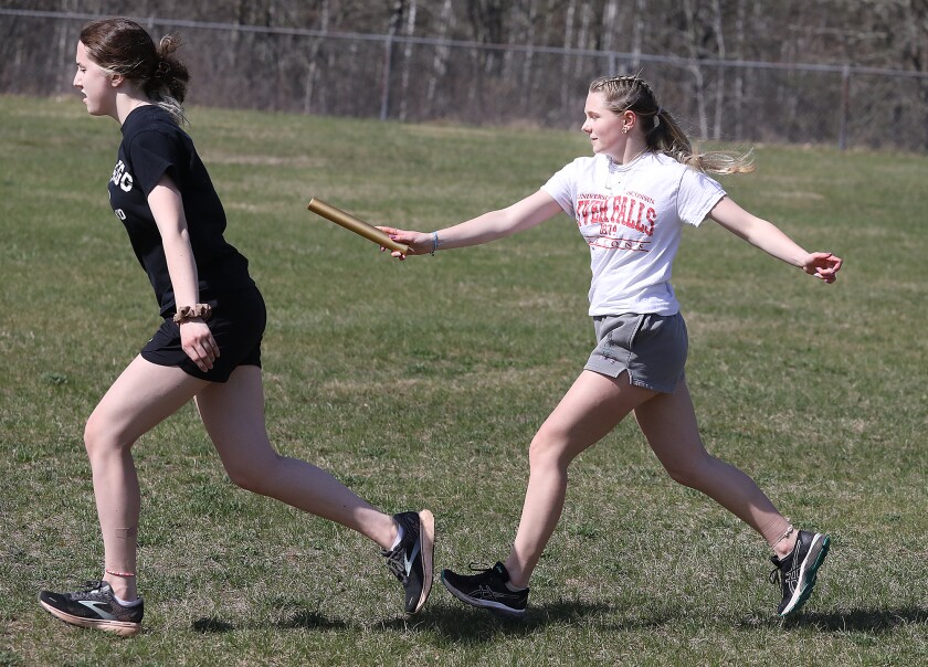 Northwood/Solon Springs’ Marianne Lear, left, gets the baton from Allie Nordskog as they work on handoffs