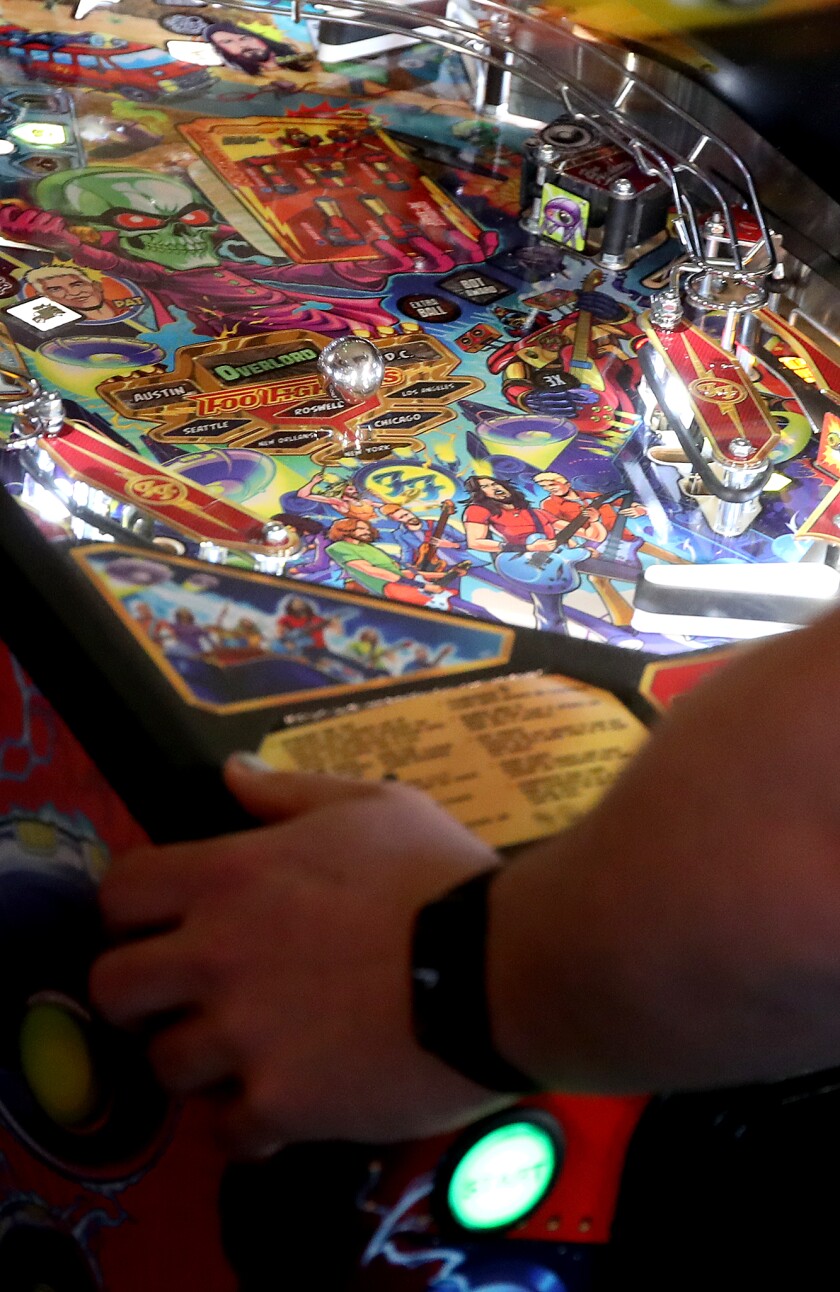 Ball rolls through pinball game.
