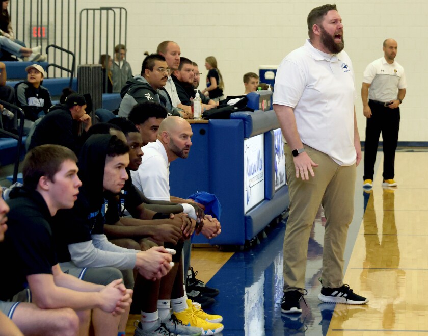 Minnesota West Team watches as head coach Brian Stoebner gives instructions as players defend against the visiting Dordt University JV during the Sanford Classic Saturday night in Worthington.