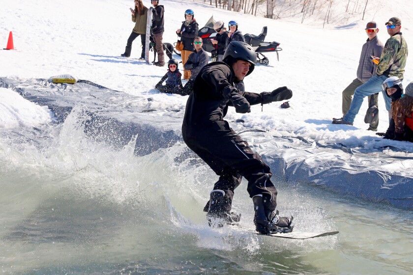 Skiers and snowboarders participate in the water skip at Mount Ski Gull on Saturday, April 8, 2023, for the end of the season.