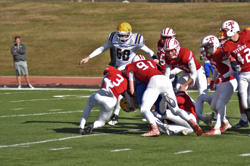 Titans junior linebacker Seth Herner and senior cornerback Kaden Kuntz gang up to tackle a Beulah ball carrier on during a Class A quarterfinal contest on Saturday, Oct. 27, from the Biesiot Activities Center. (Shelby Reardon/The Dickinson Press)