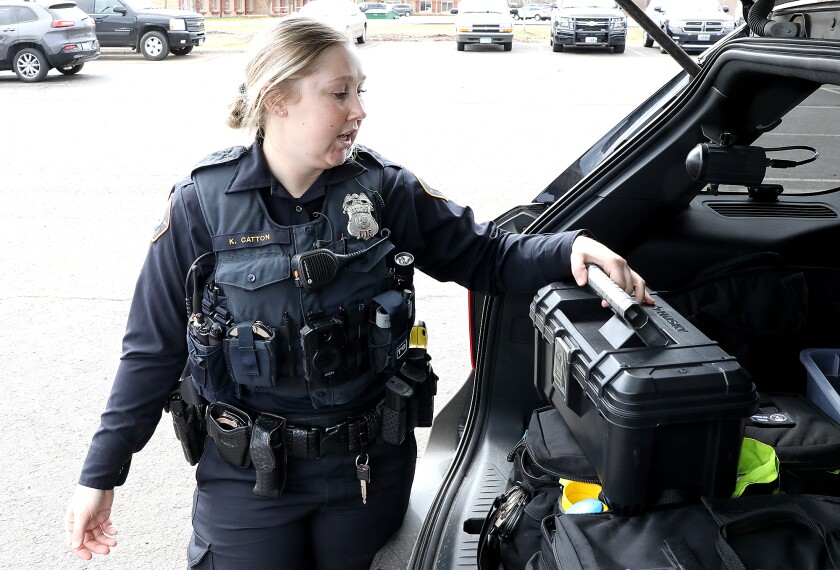 New Duluth Police Officer Katie Catton goes through a kit in the back of her squad