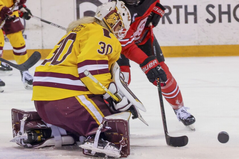 college women compete in hockey game