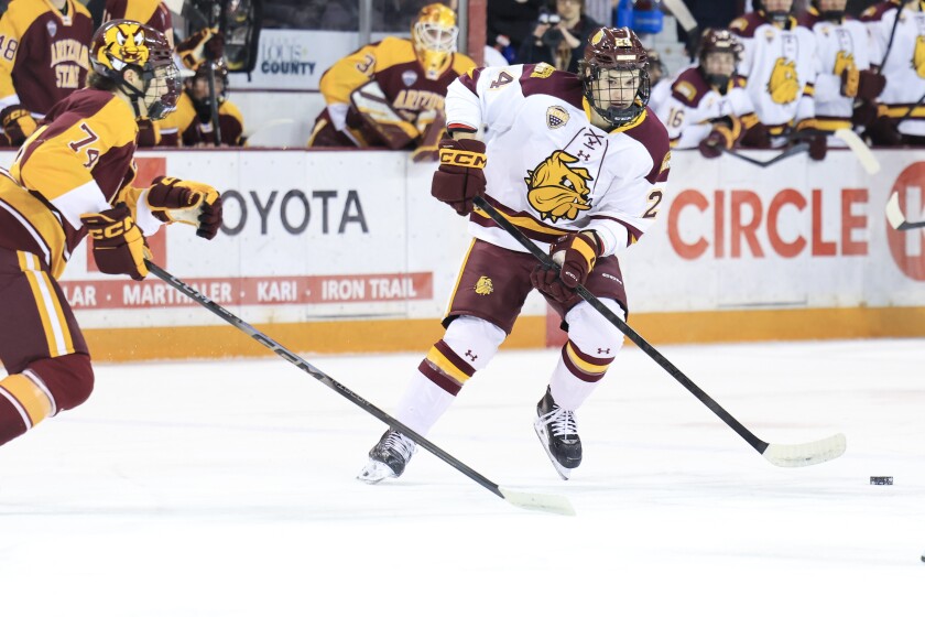 college men play ice hockey