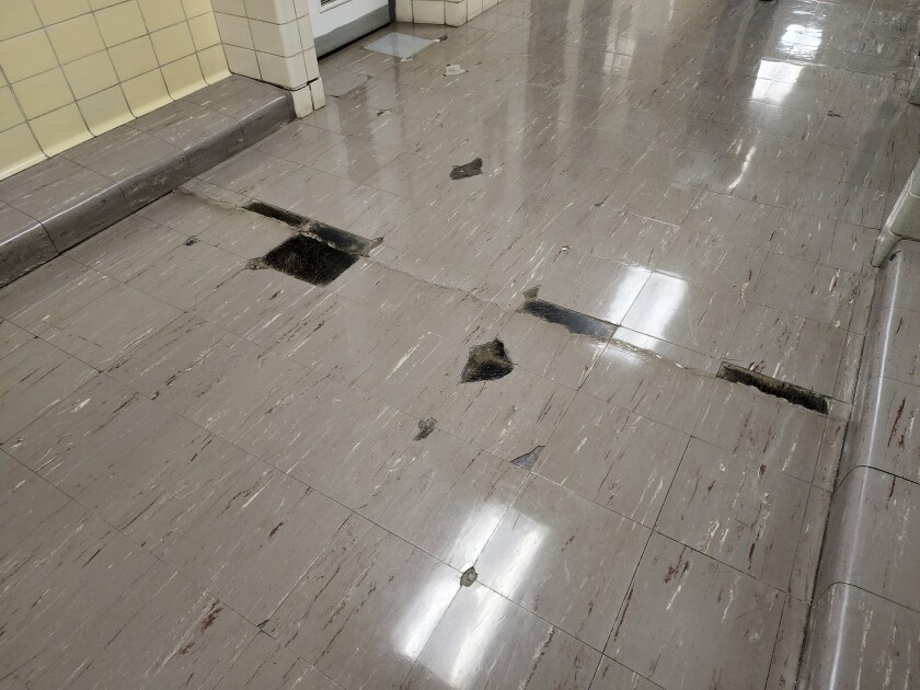 According to the IGS facility assessment, West Learning Center's floor tile and its associated adhesives are presumed to contain asbestos based on the age of the materials, but testing would be required to confirm its presence. If it is present, it would need to be abated in order to serve as a child care facility.