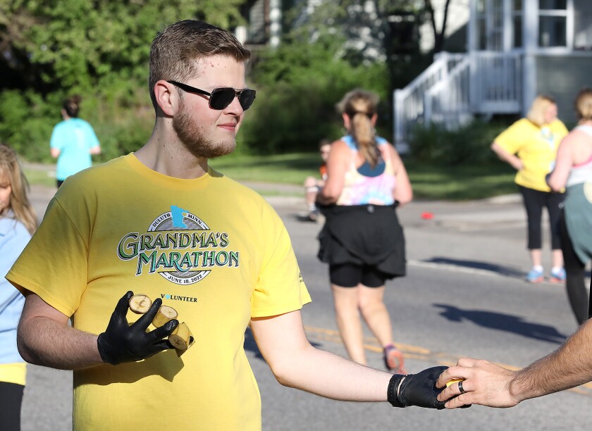 Volunteer Derek Grafmyre, of Duluth, hands out bananas to runners along London Road