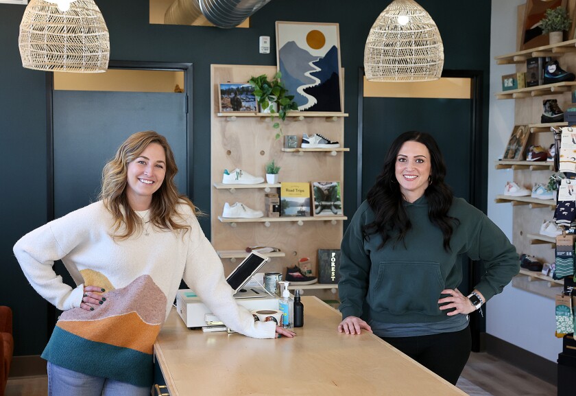 Women pose at counter.