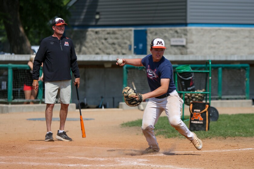 Moorhead Spuds baseball player Carter Huotari throws to first base during practice Wednesday, June 4, 2025, at Matson Field in Moorhead as head coach Greg Salvevold looks on.