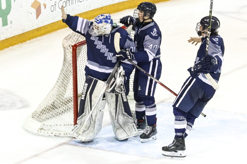 high school boys play ice hockey