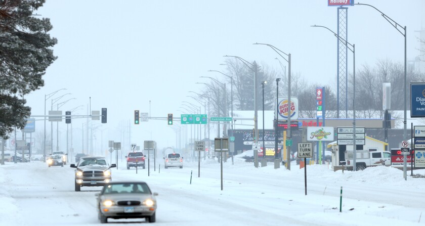 Traffic moves slowly down Oxford and Humiston Ave. as an Alberta Clipper moves through the Worthington area that is under a Winter Storm Warning until Saturday morning.