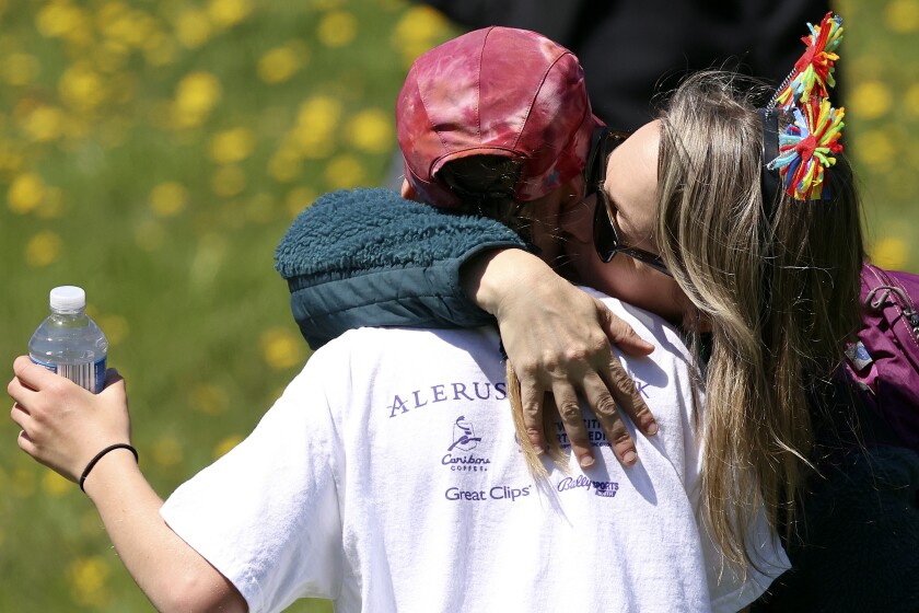 Iris Rude, 11, is congratulated by mother Natalie Salinen Rude.