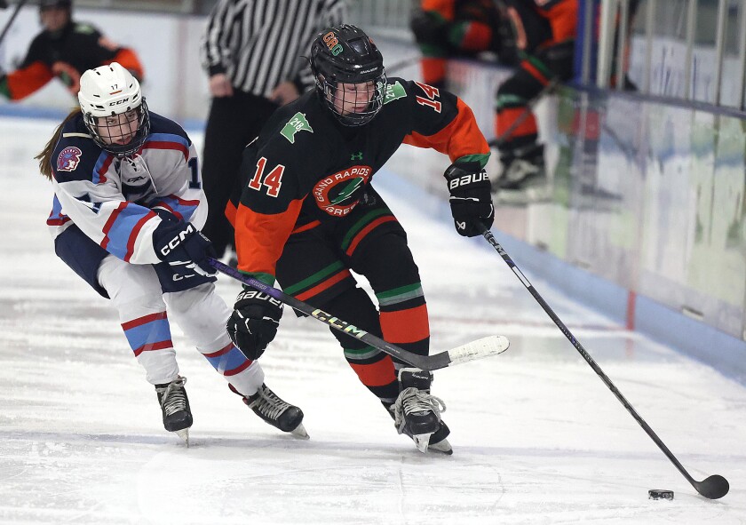 Player skates with puck.