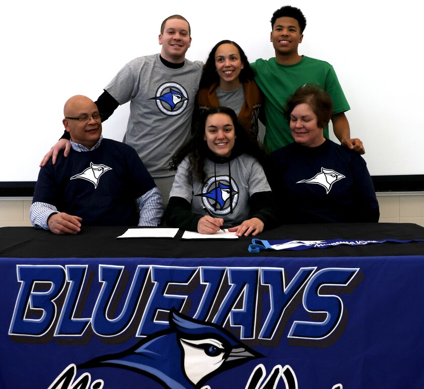 Worthington Trojans Dasia Potter signs a letter of intent to play basketball for Minnesota West with her family, (front row left)father Mike, Dasia and mother Suzie Potter (back from left) brother Marcus and sister and nephew Lakeyta and Jacari Swinea.