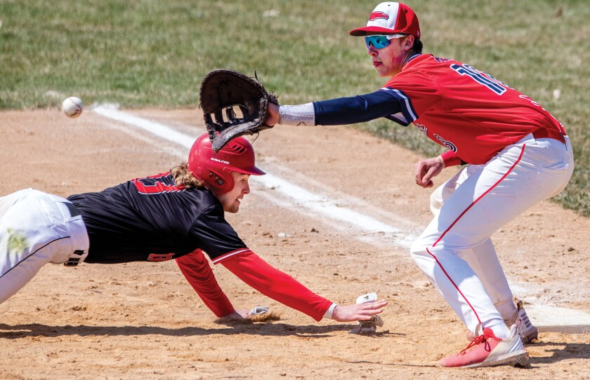 Jadrien Keavy of Ridgewater College slides back to first base as Gunnar Wicklund of Central Lakes College attempts to tag him out during the first game of a doubleheader at Green Lake Baseball Diamonds in Spicer on Wednesday, April 27, 2022.