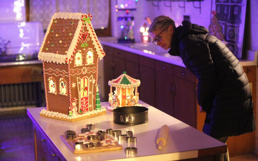 Woman looks at decorated gingerbread displays