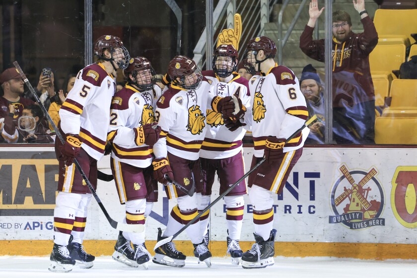college men play ice hockey