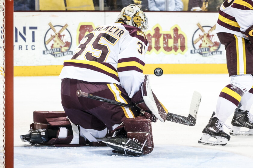 college men play ice hockey indoors