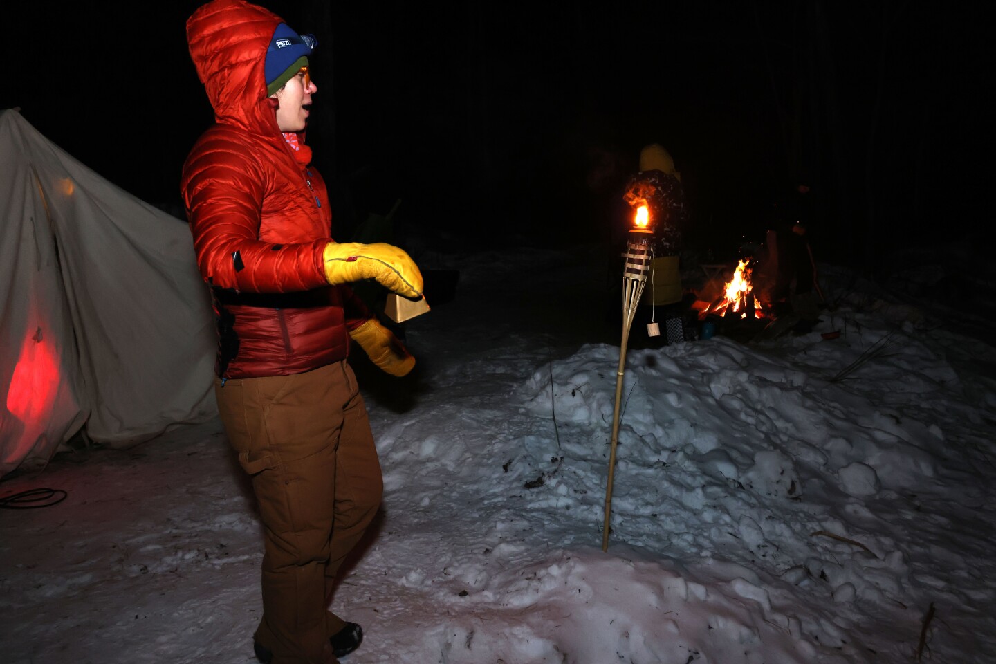 Volunteer rings cowbell and cheers on racers