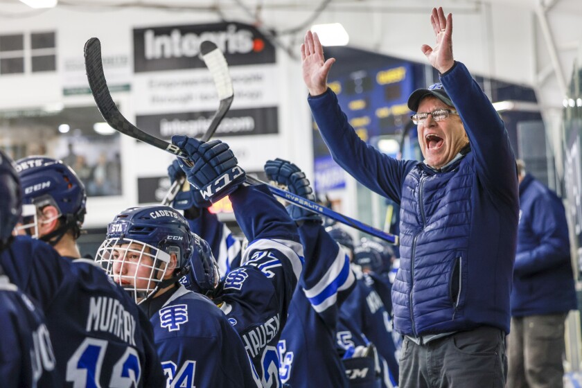 man coaches ice hockey
