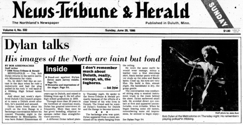 Newspaper clipping shows front page of Duluth News-Tribune and Herald on June 29, 1986 with the headline "Dylan talks" and photo of the artist in concert.