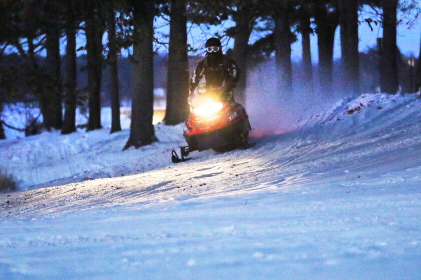 A snowmobiler pops over the crest of a hill Thursday at Lum Park in Brainerd. Kelly Humphrey / Brainerd Dispatch