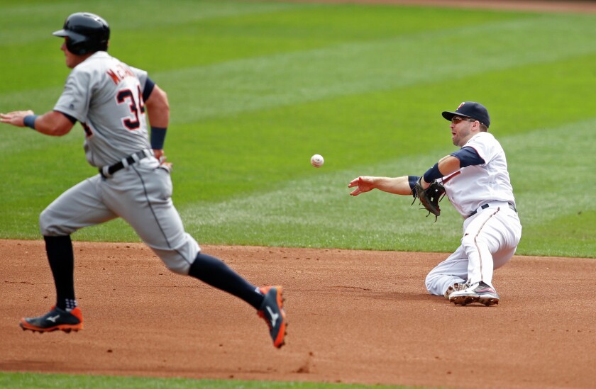 Minnesota Twins second baseman Brian Dozier (2) fields a ball but throws it away for an error trying to double up Detroit Tigers catcher James McCann (34) and allows a run for the Tigers in the second inning Thursday at Target Field. Bruce Kluckhohn-USA TODAY Sports