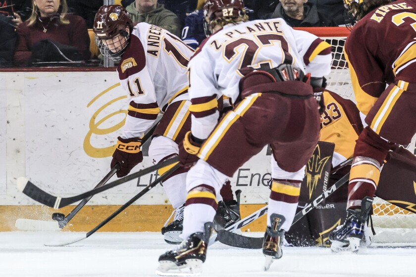 college men play ice hockey