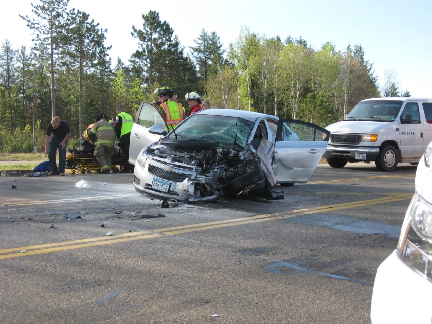 Emergency personnel assist a woman ho was involved in a crash Monday morning on Wise Road, near Beaver Beaver Dam Road. (Jennifer Stockinger)