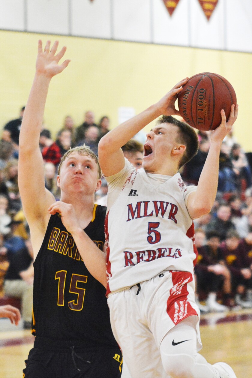 Moose Lake-Willow River's Avery Kosloski works to get a shot past Barnum's Samuel Goodwin during Friday night's boys basketball action in Barnum. Kosloski scored 14 points in the 47-44 Rebels win. Dan Saletel/Pine Journal