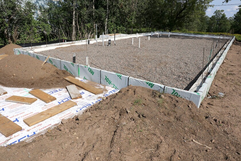 The foundation for the house being built by Green New Deal Housing at 108 East 11th Street in Duluth sits ready Monday