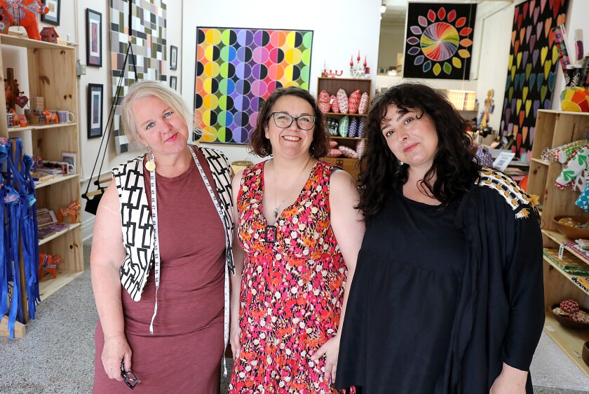 Kirsten Aune, left, Darcy Zeppernick, center, and Kristen Kaas pose together in Kirsten Aune Textiles in Duluth