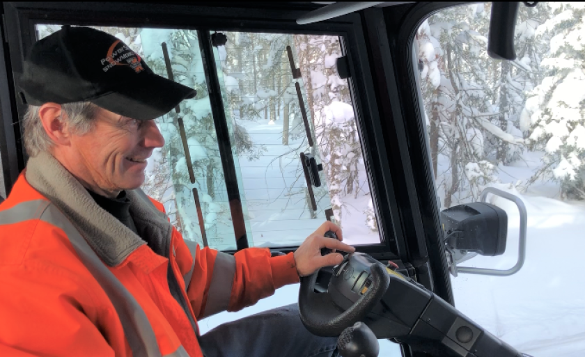 Greg Libby operates a trail groomer on the Pequaywan Snowmobile Trail