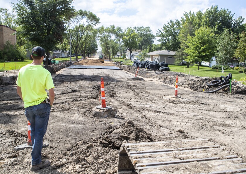 Maison Olson of Bolton & Menk Inc. watches as road work is conducted along 6th Street SW in Willmar on Tuesday, August 16, 2022.